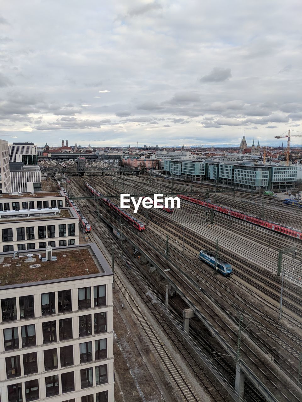 High angle view of railroad tracks and cityscape against sky