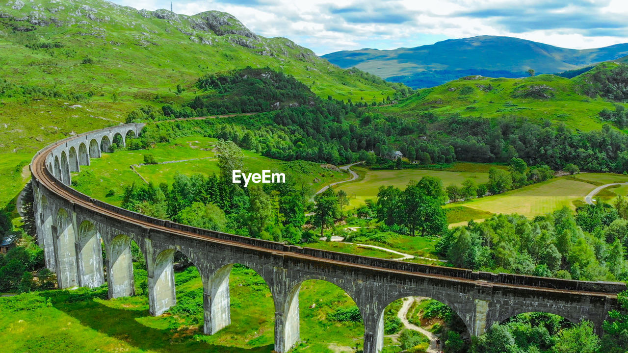 PANORAMIC VIEW OF BRIDGE OVER MOUNTAINS AGAINST SKY