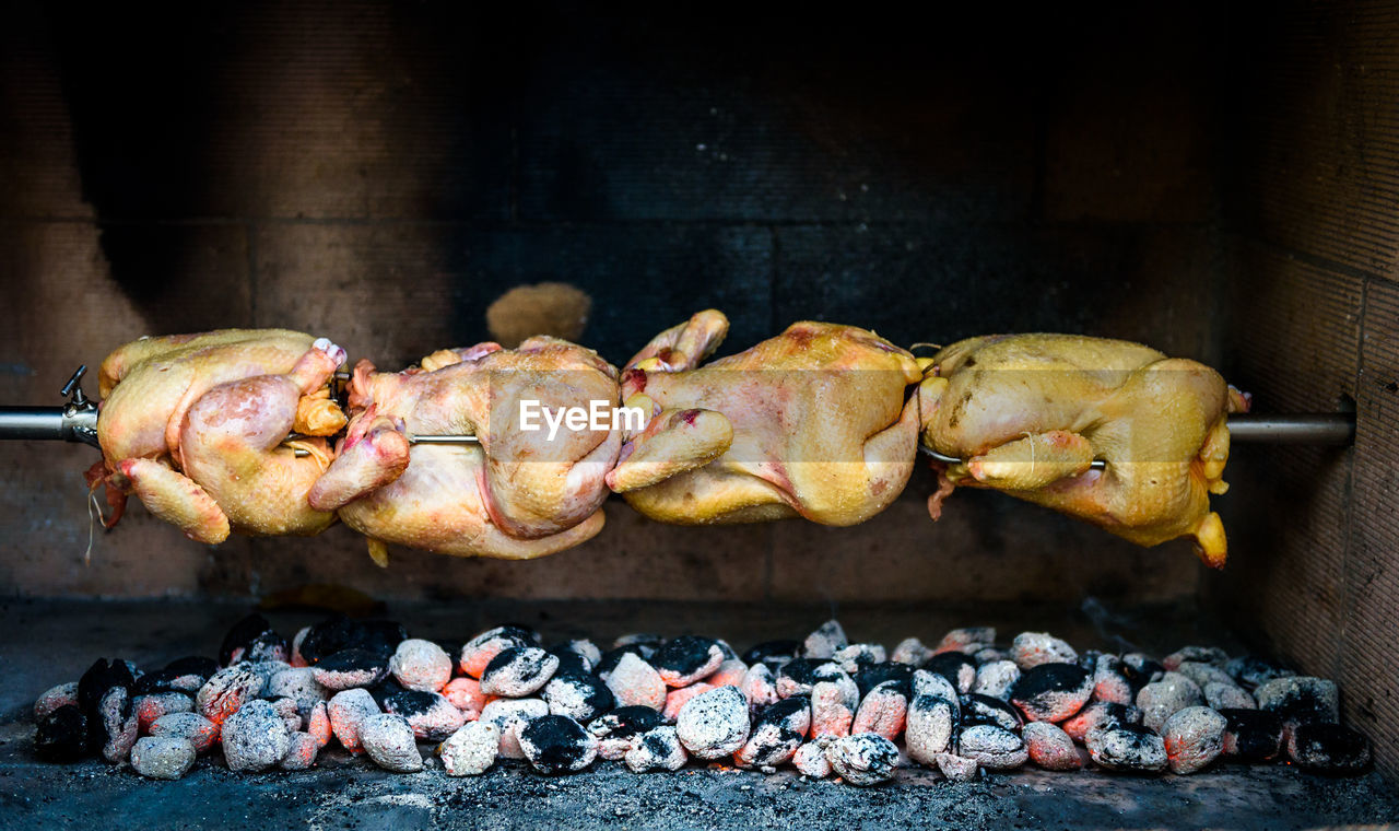 Close-up of meat hanging on coal