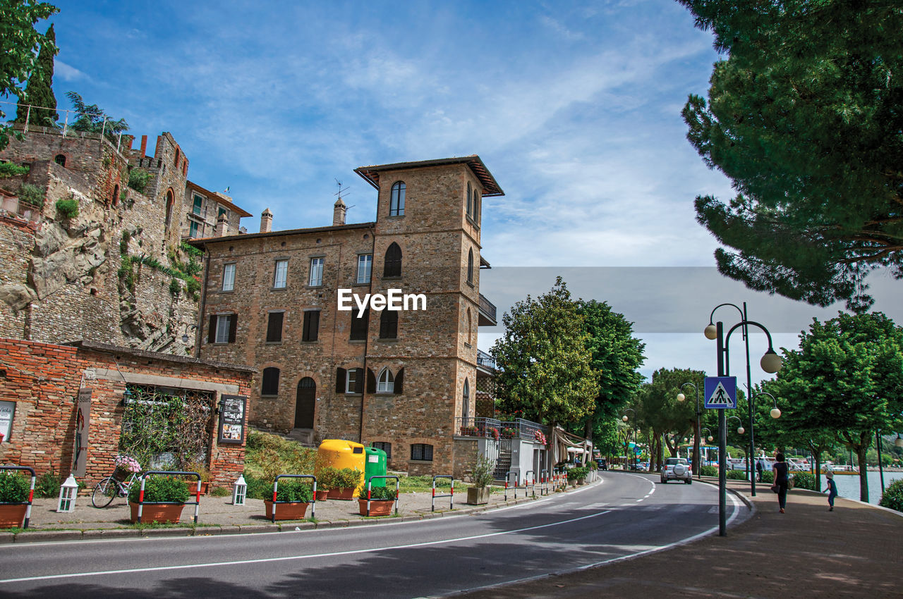 View of promenade in a village at the shore of lake trasimeno, italy.