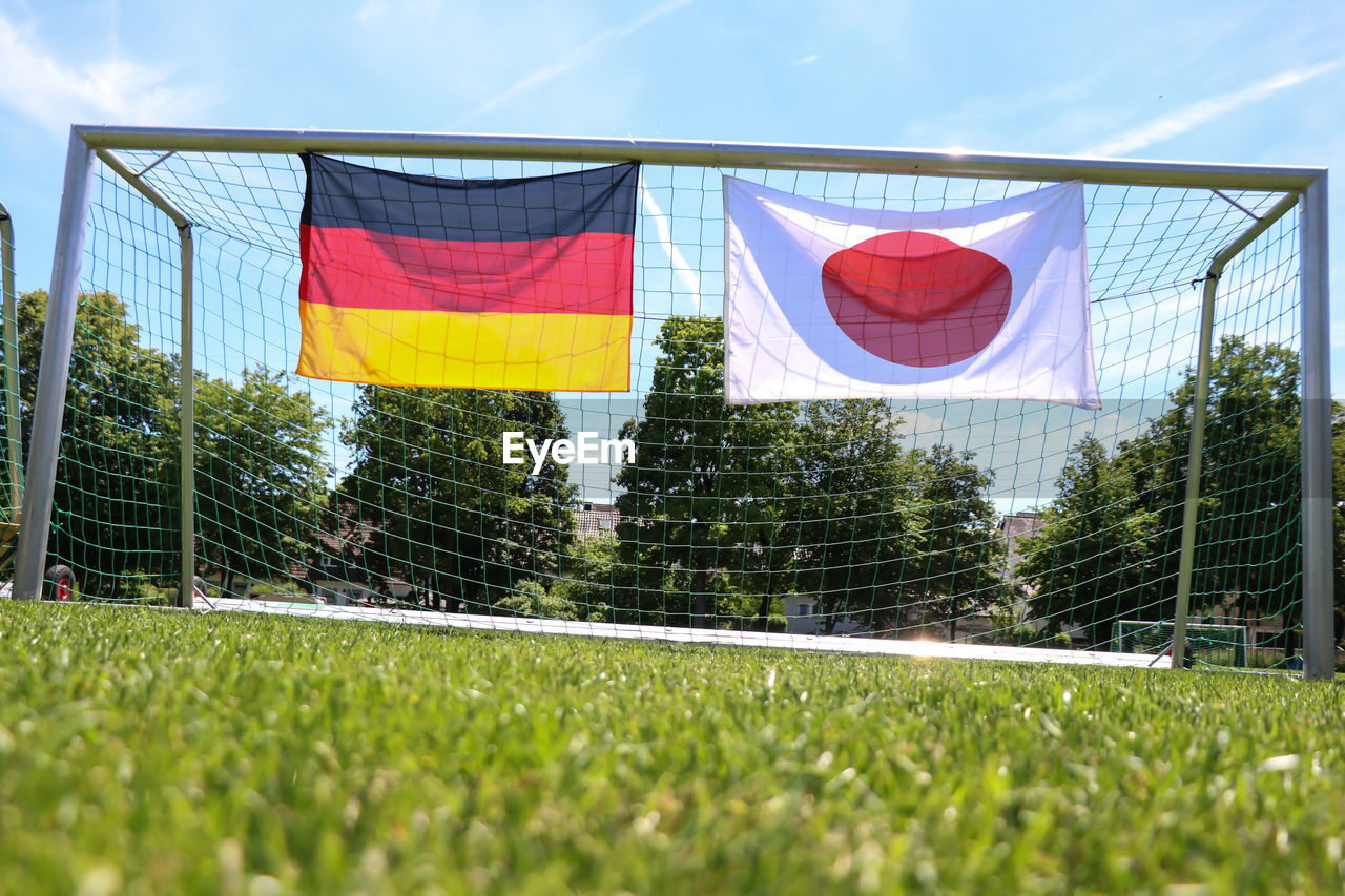  flags on soccer field against sky