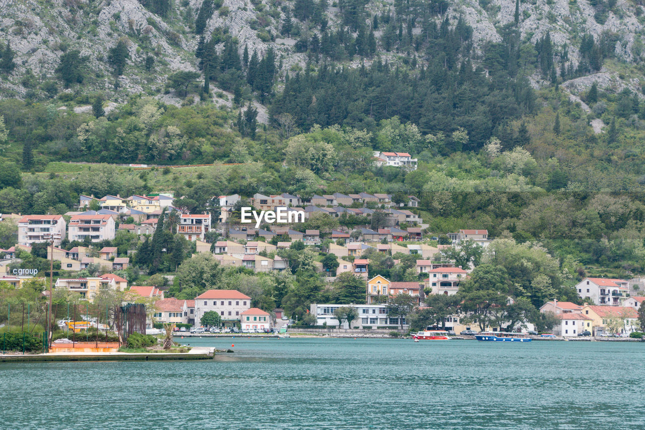 Scenic view of sea by buildings in city