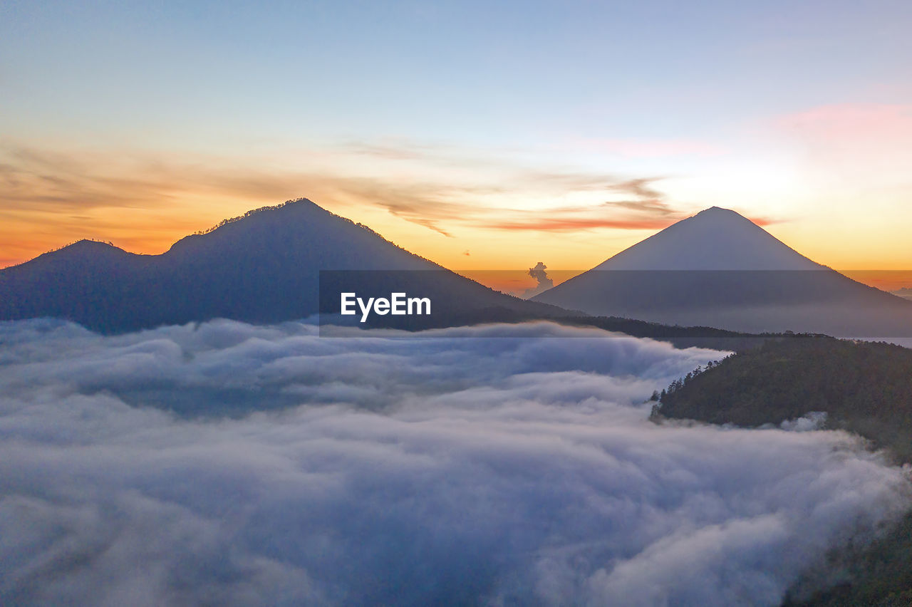 SCENIC VIEW OF MOUNTAINS AGAINST ORANGE SKY