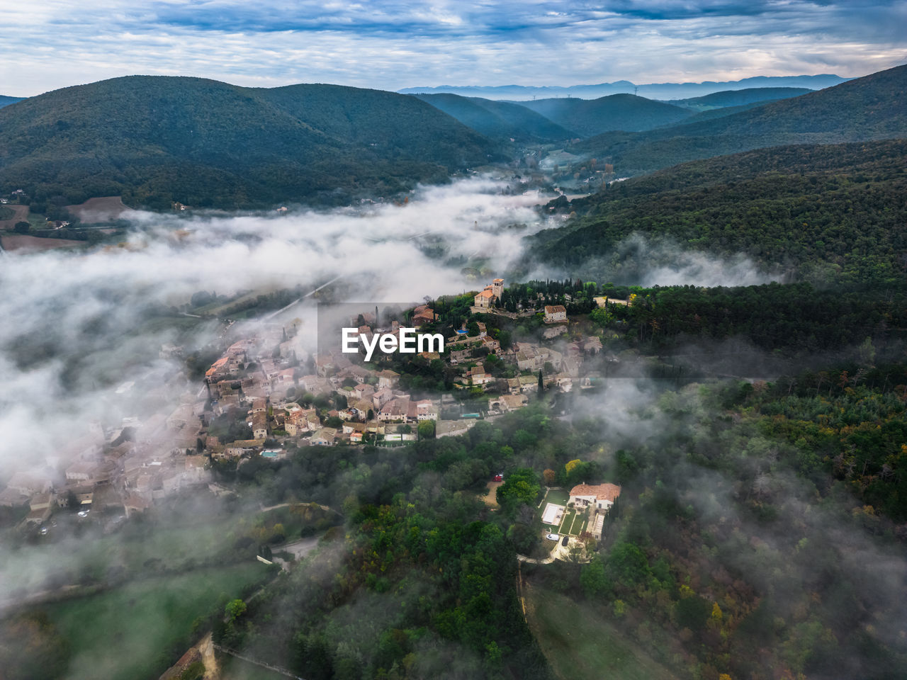 Panoramic view of the old village of mirmande. aerial photo in the morning in the thick fog rising 