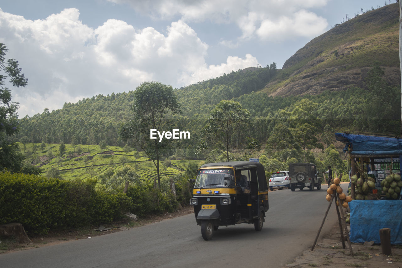 CAR ON ROAD AGAINST SKY