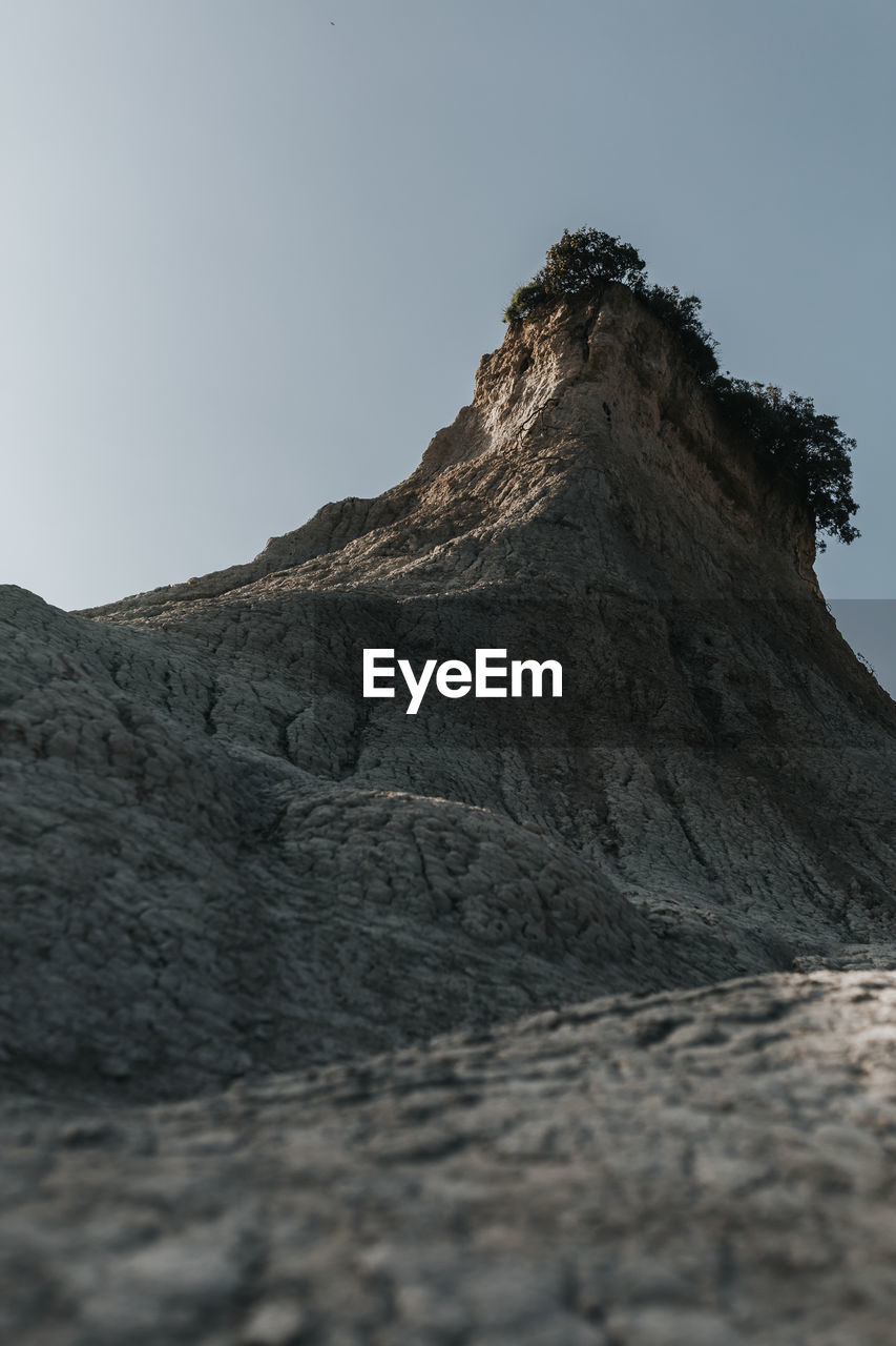 Low angle view of rock formations against sky