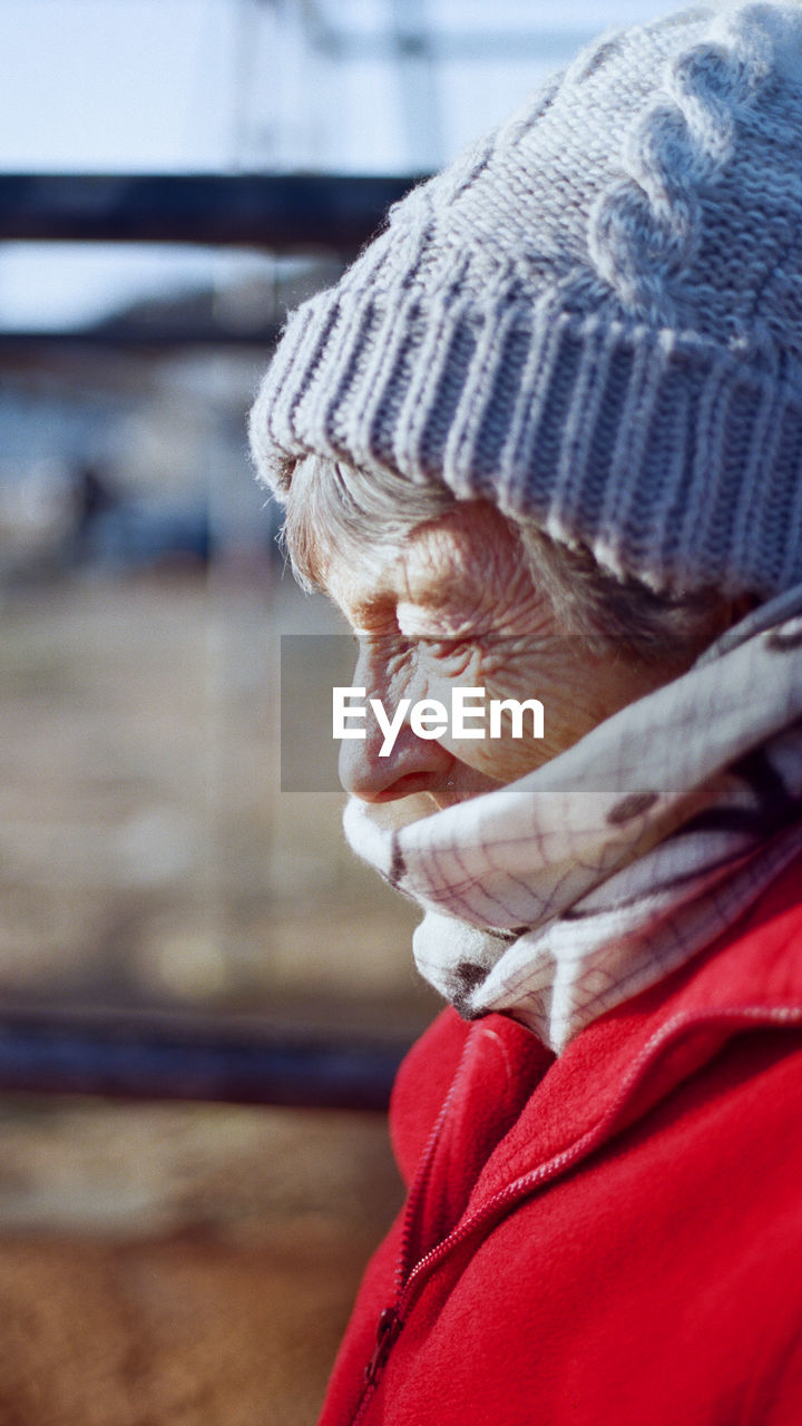 Side view of senior woman wearing knit hat