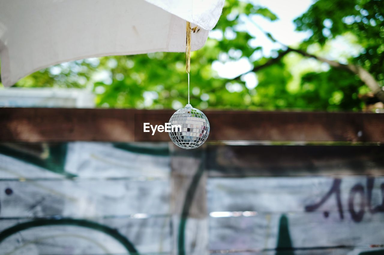 Disco ball hanging on roof outdoors