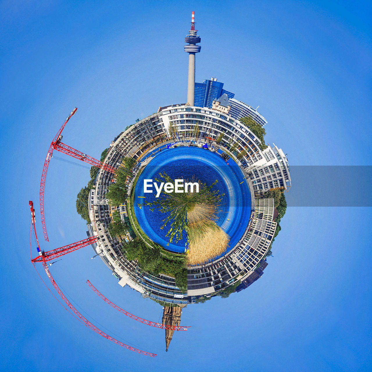 Little planet effect of olympiaturm and crane in city against sky