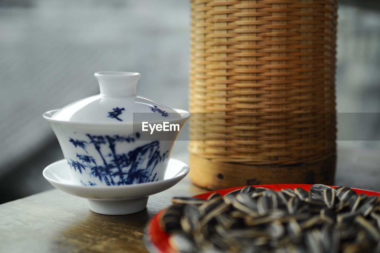 CLOSE-UP OF TEA CUP IN BASKET