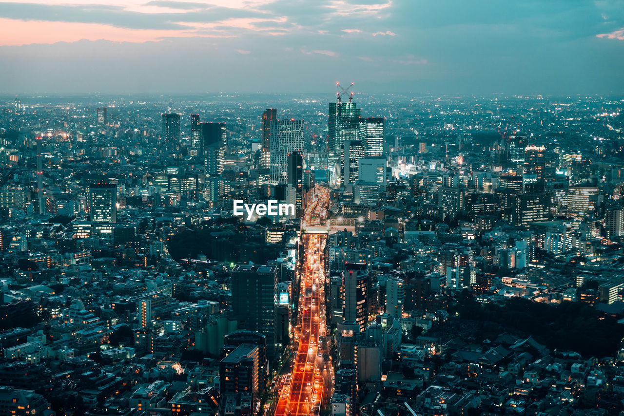 High angle view of city lit up at dusk