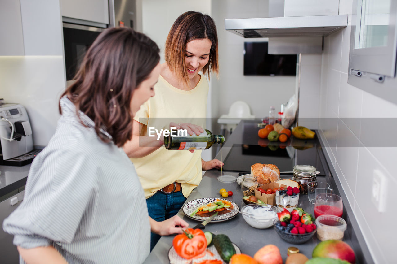 Women preparing food at kitchen