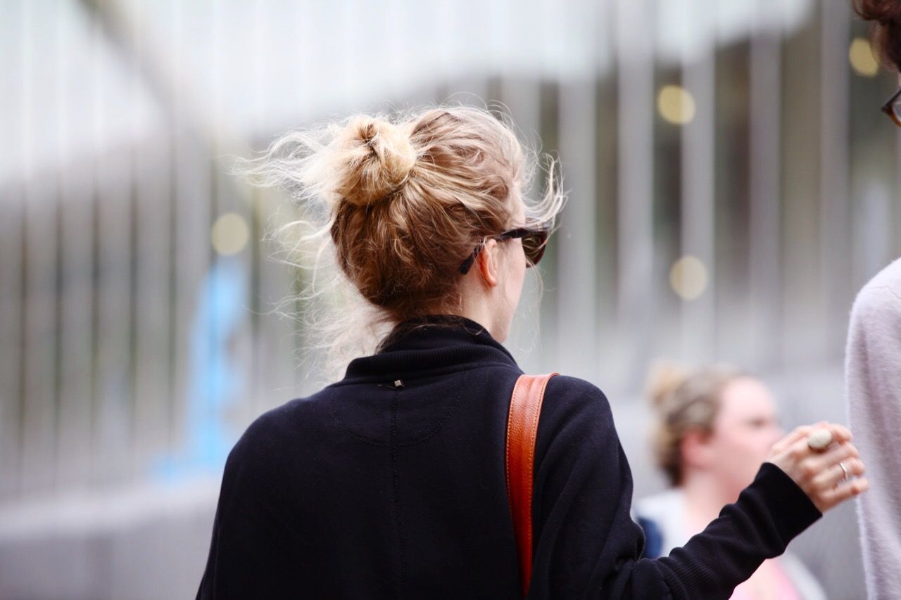 REAR VIEW OF YOUNG WOMAN