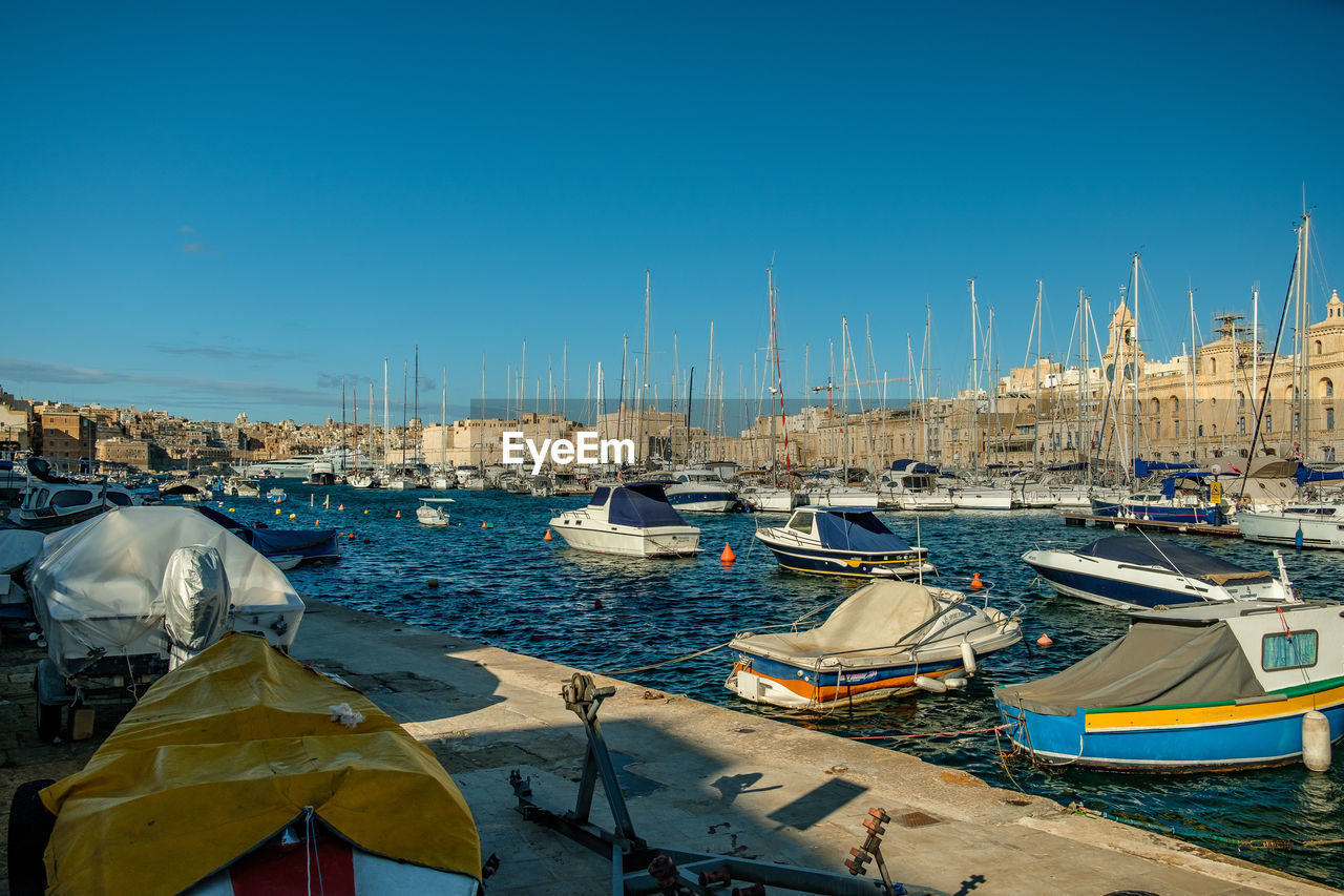 Marina with sailing boats in front of historical mediterranean city scenery