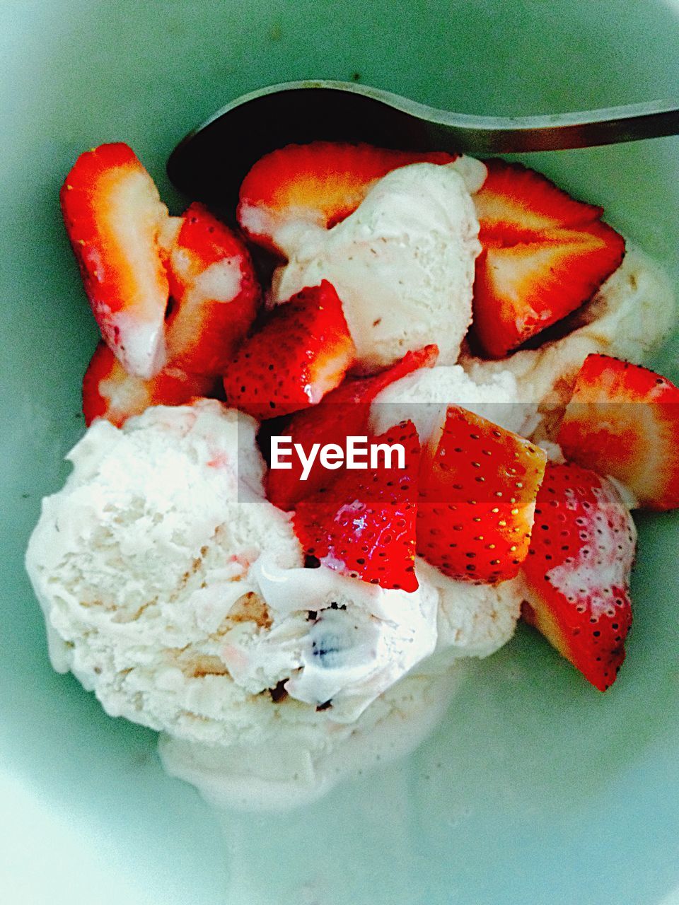 High angle view of ice cream with strawberries in bowl