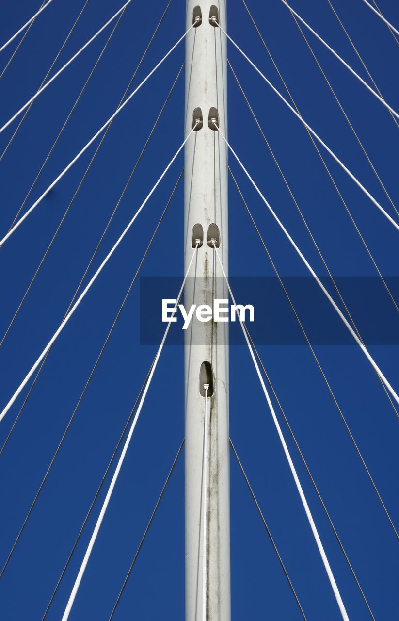LOW ANGLE VIEW OF POLE AGAINST BLUE SKY