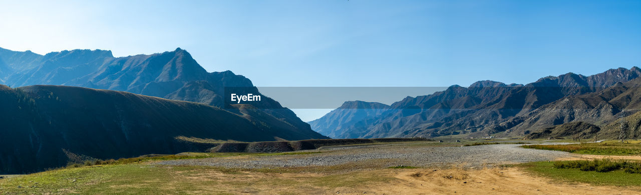 SCENIC VIEW OF MOUNTAINS AGAINST BLUE SKY