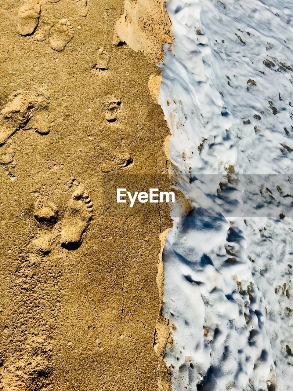 High angle view of sand and sea on beach