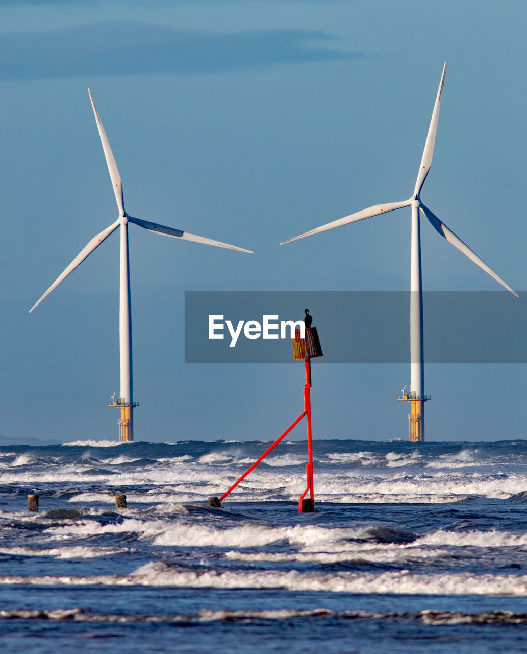 WINDMILL ON SEA AGAINST SKY