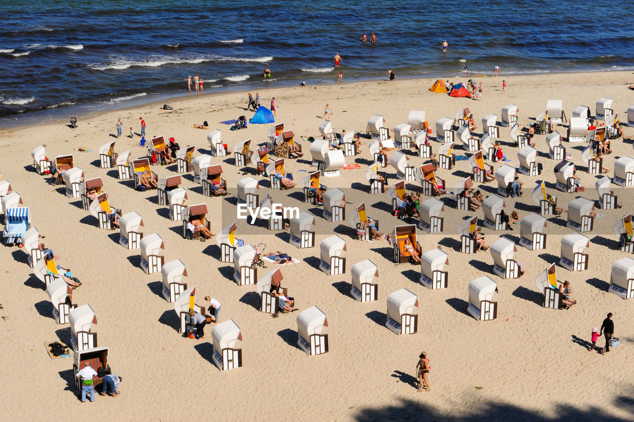High angle view of hooded beach chairs at beach during summer