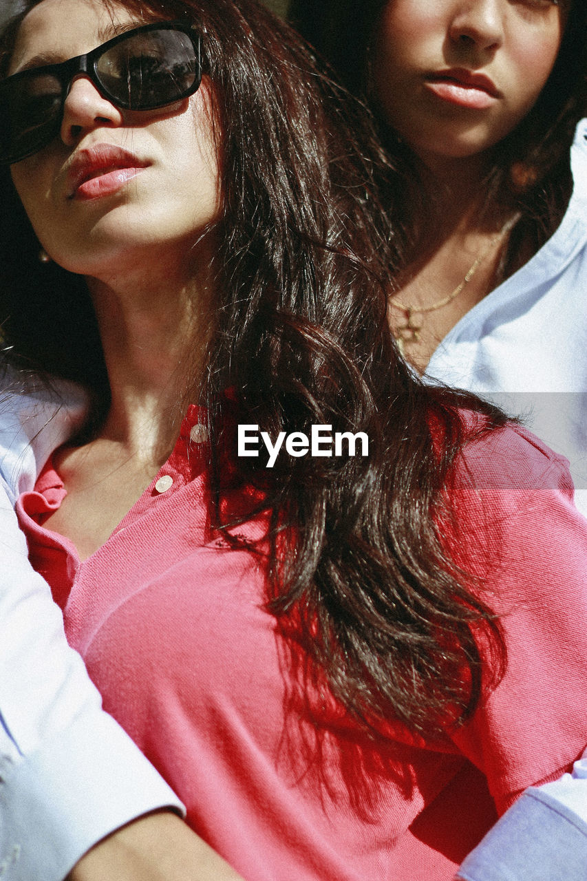 Close-up of woman embracing female friend outdoors