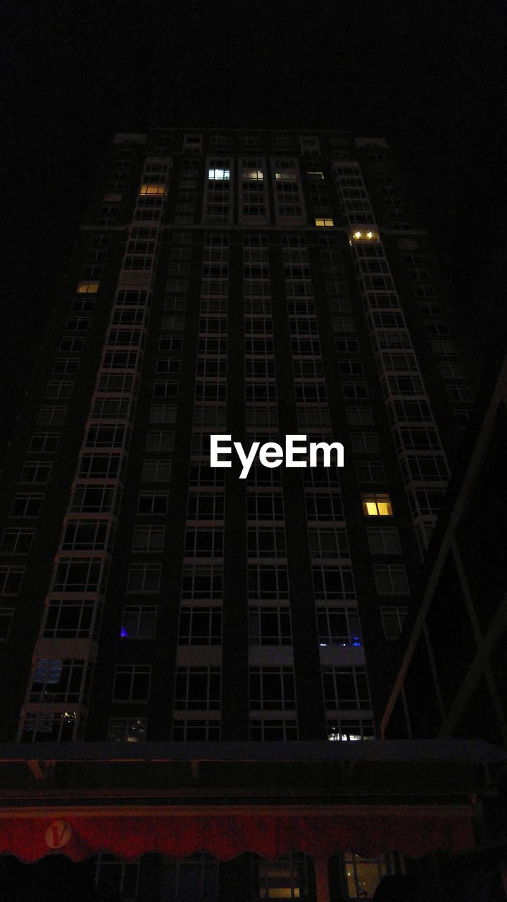 LOW ANGLE VIEW OF BUILDINGS IN CITY AT NIGHT