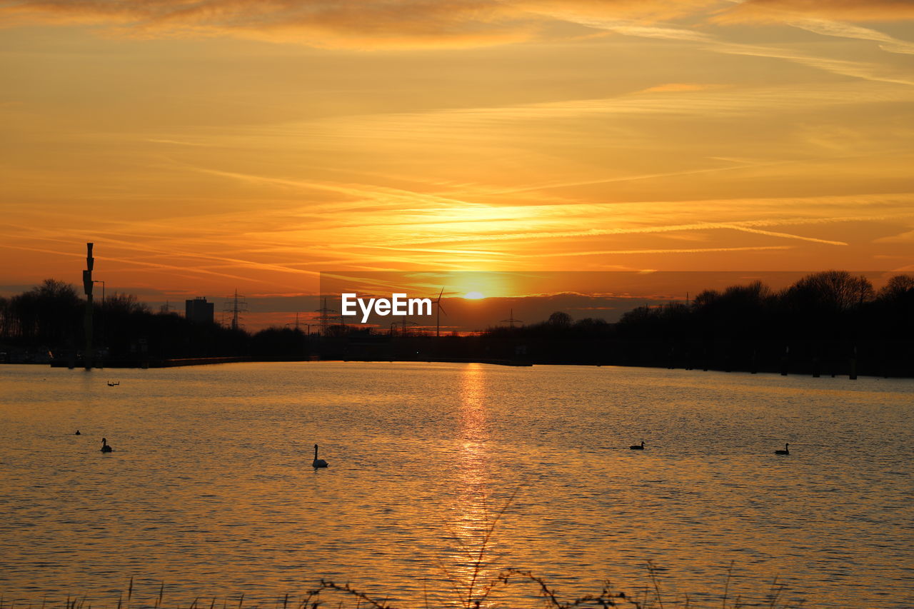 Scenic view of lake against orange sky