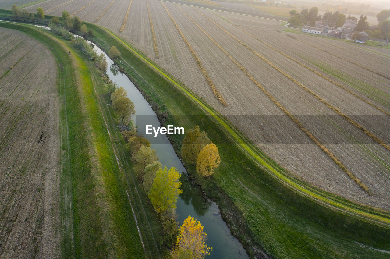 High angle view of canal amidst agricultural field