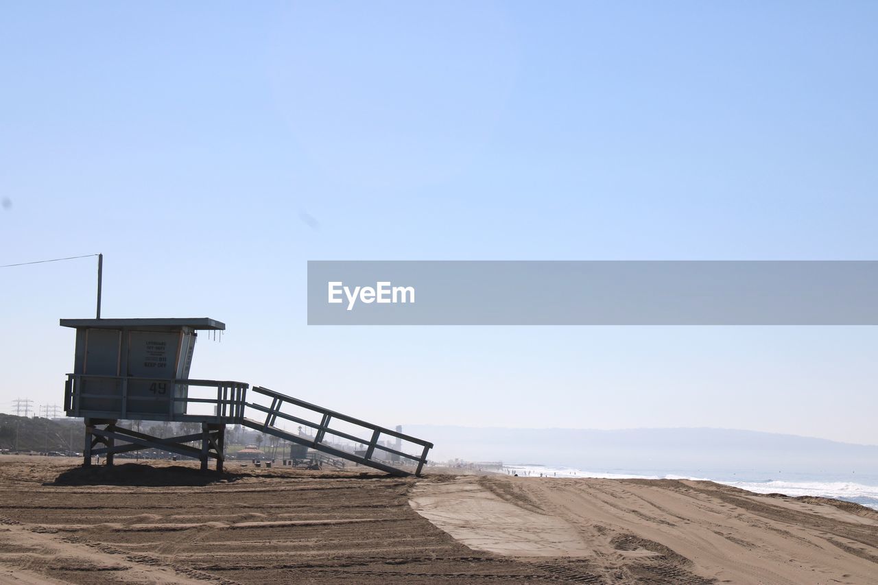 LIFEGUARD HUT ON BEACH AGAINST SKY