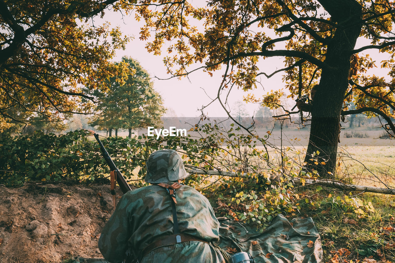 Rear view of army soldier in forest