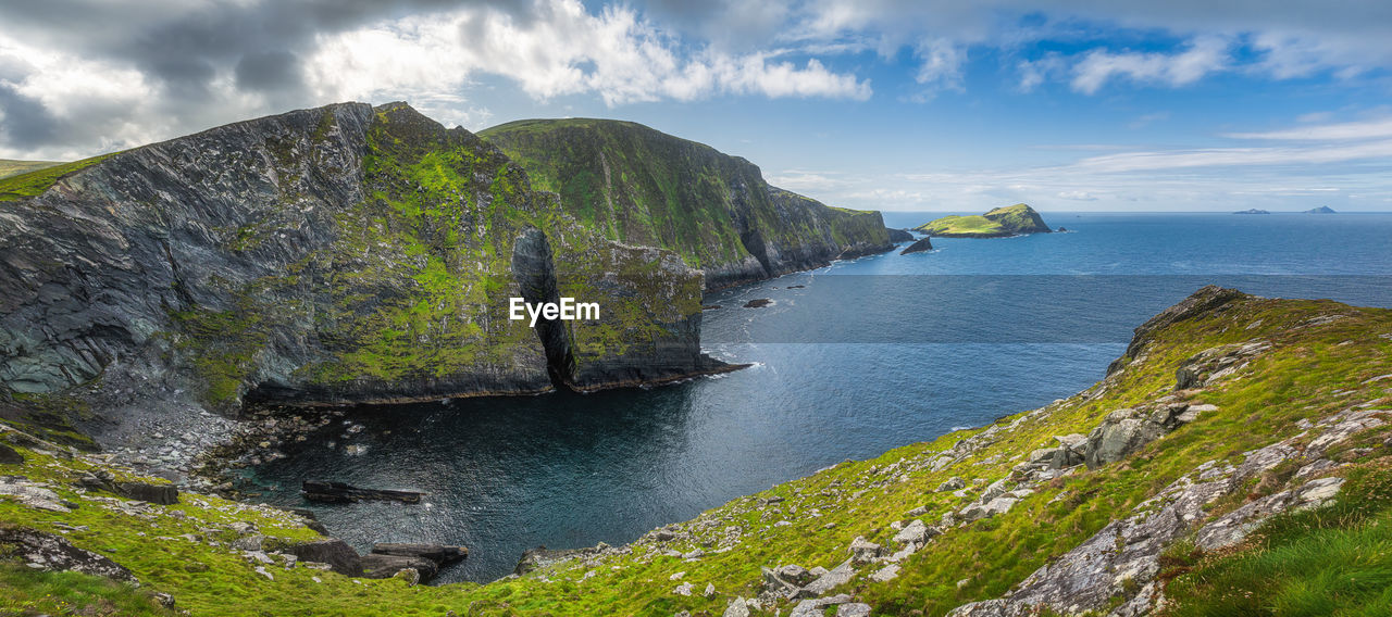 Tall kerry cliffs and a view on skellig michael island where star wars were filmed, ireland