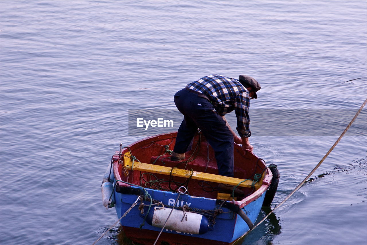 Rear view of a man in boat