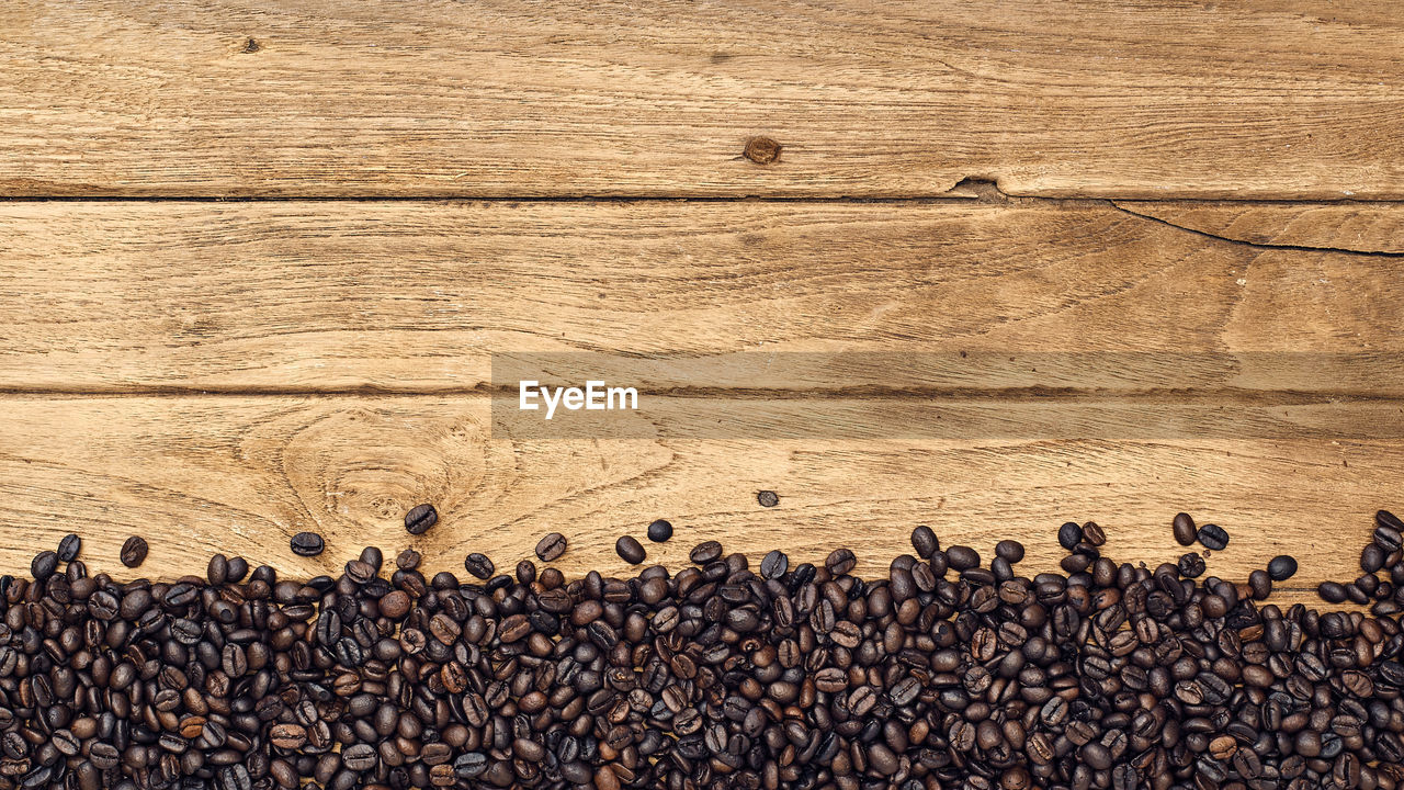 Directly above shot of coffee beans on wooden table