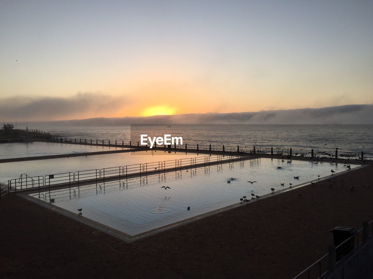 SCENIC VIEW OF SEA AT SUNSET