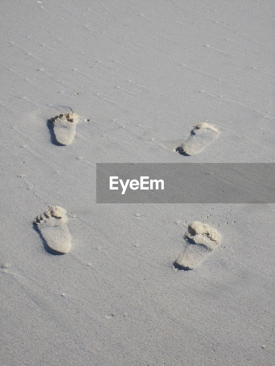 High angle view of footprints on sand at beach