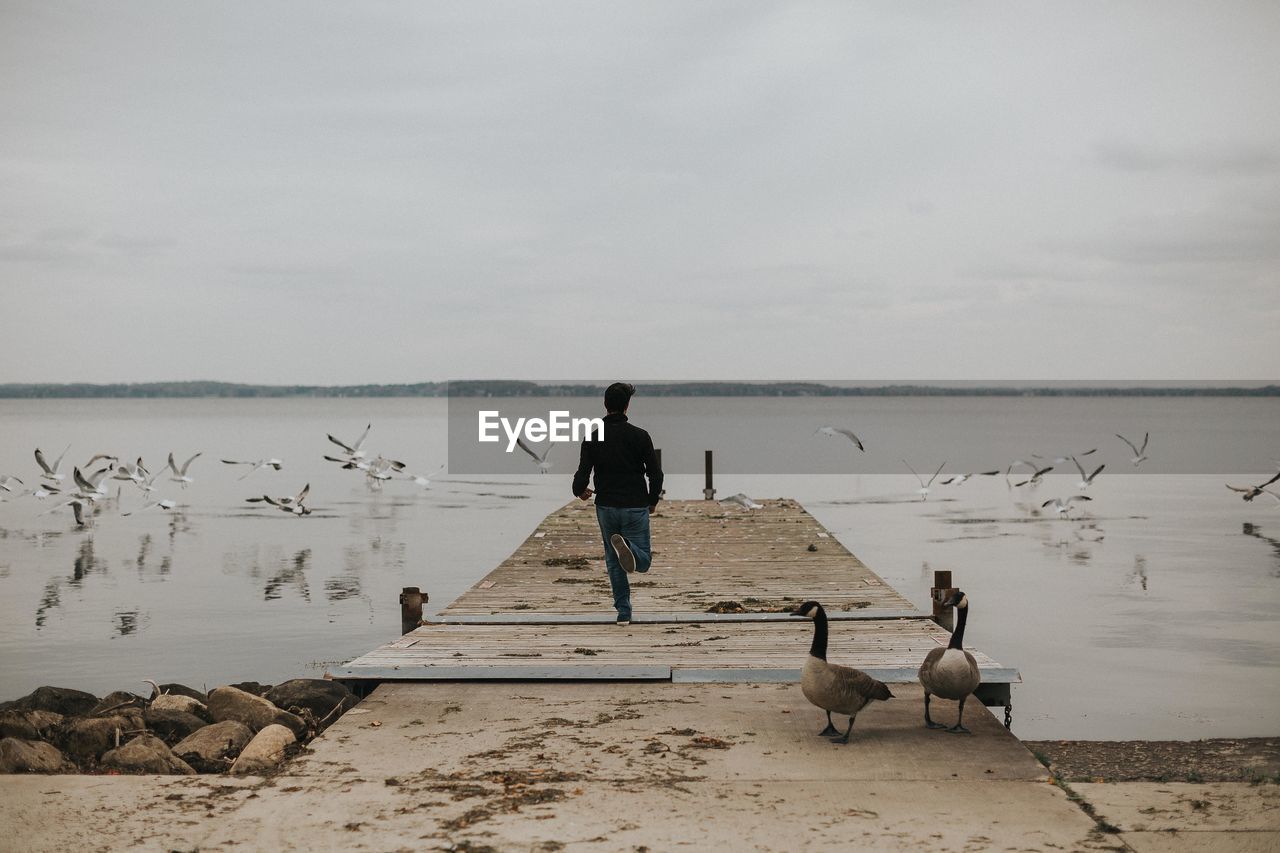 Man on beach against sky