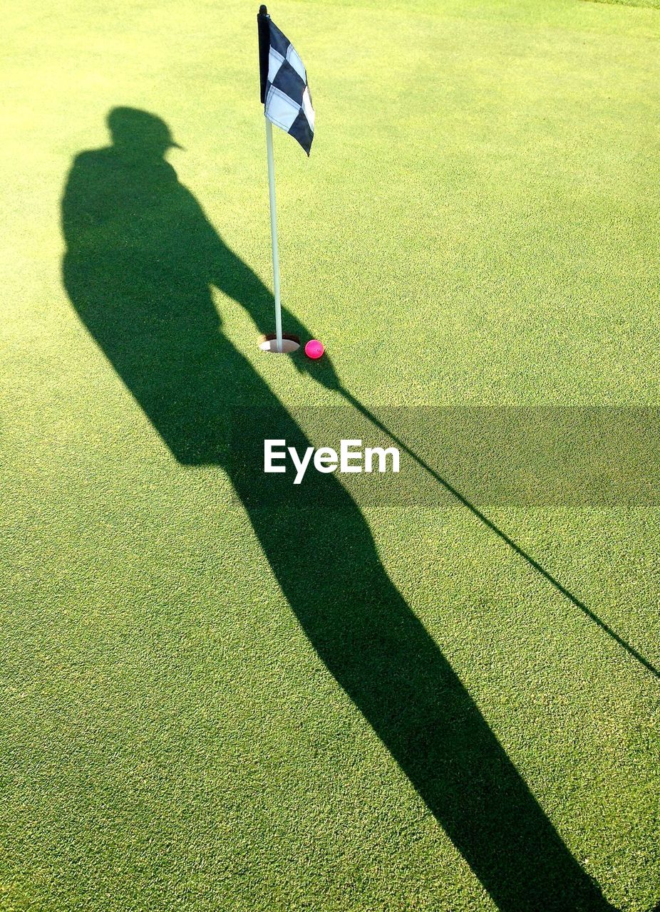 Shadow of person on golf court