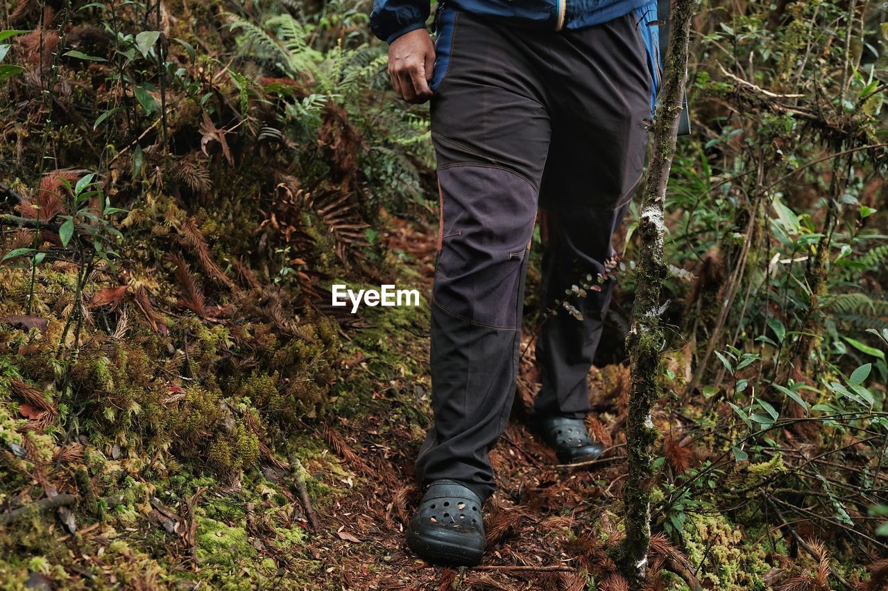 LOW SECTION OF MAN STANDING ON GROUND