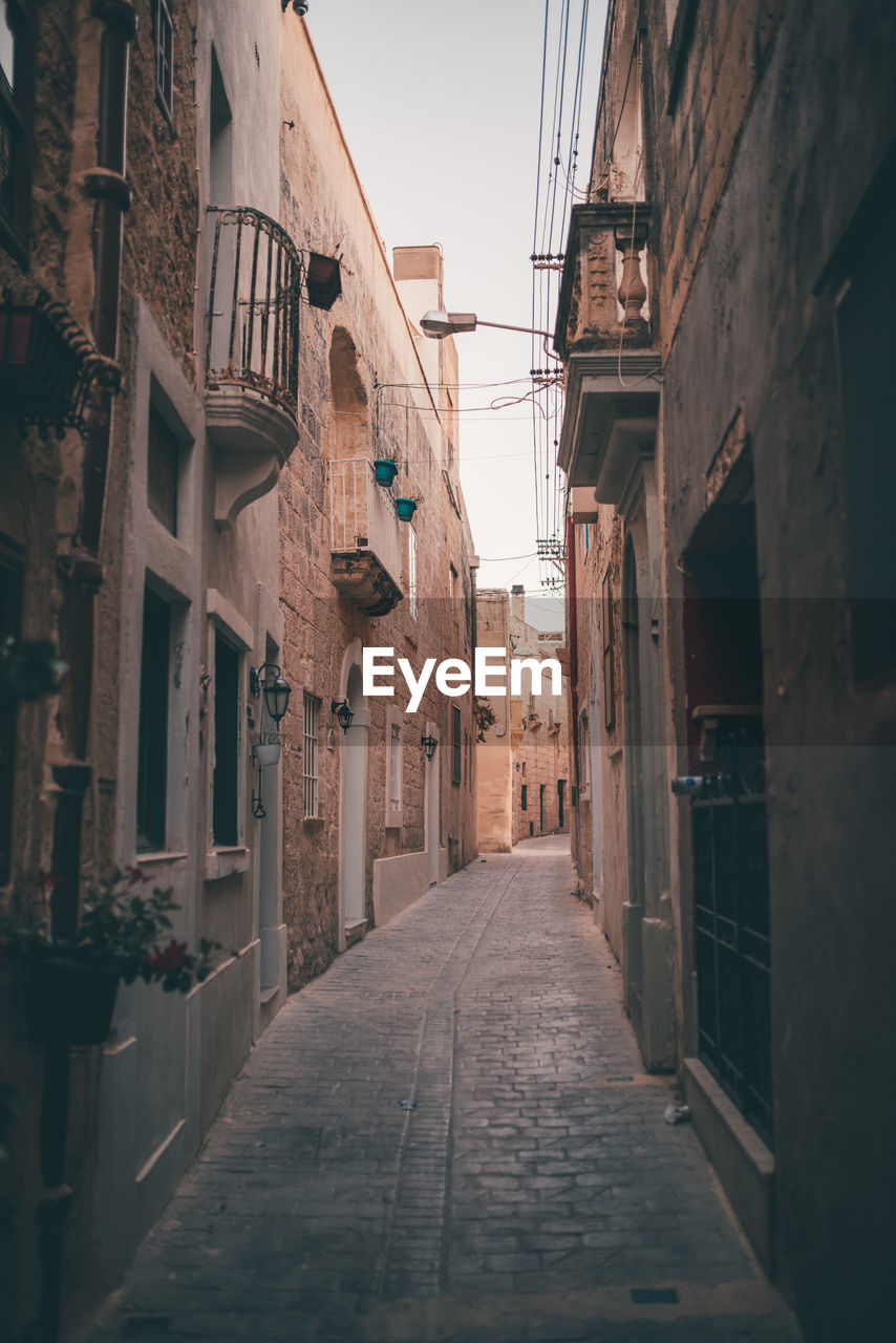 Narrow alley amidst buildings in city