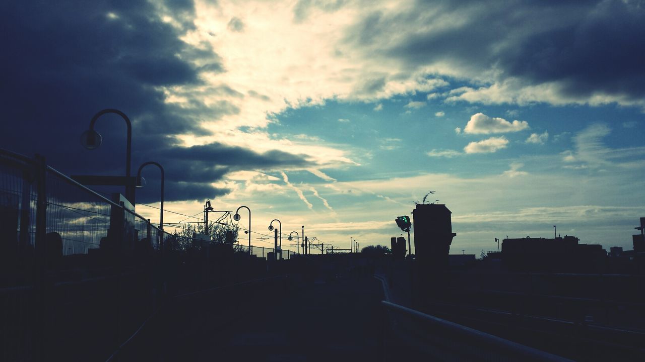 Silhouette field against sky