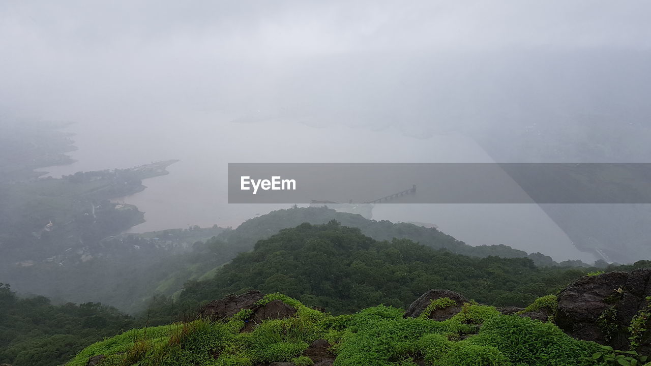 Scenic view of mountains against sky during rainy season