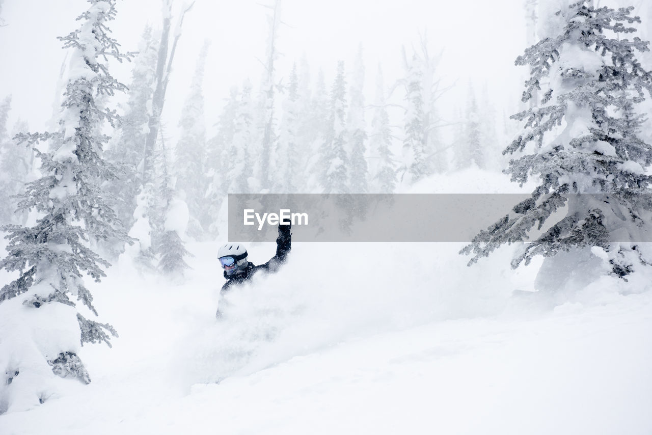 Asnowboarder finds pure happiness taking a turn in deep powder