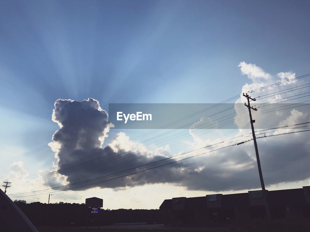 LOW ANGLE VIEW OF SILHOUETTE CABLES AGAINST SKY