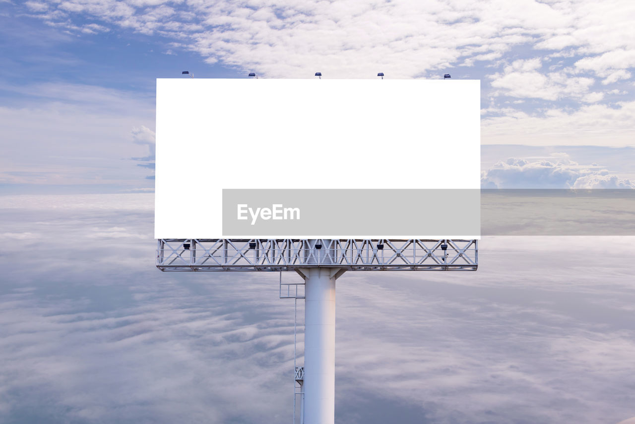 LOW ANGLE VIEW OF SIGN AGAINST SKY