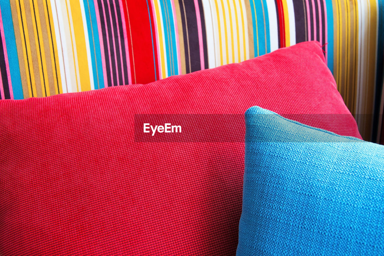 Close-up of cushions on colorful sofa