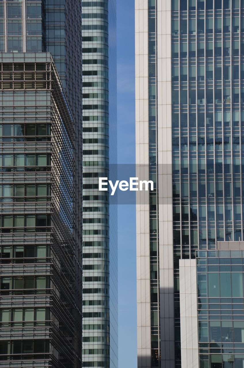 Low angle view of modern glass building in city