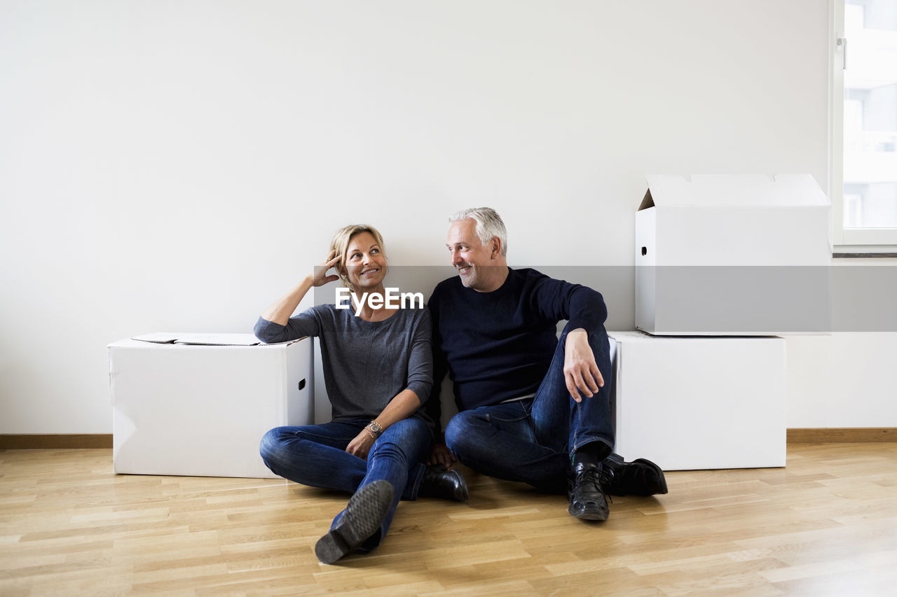 Mature couple relaxing after moving into their new house