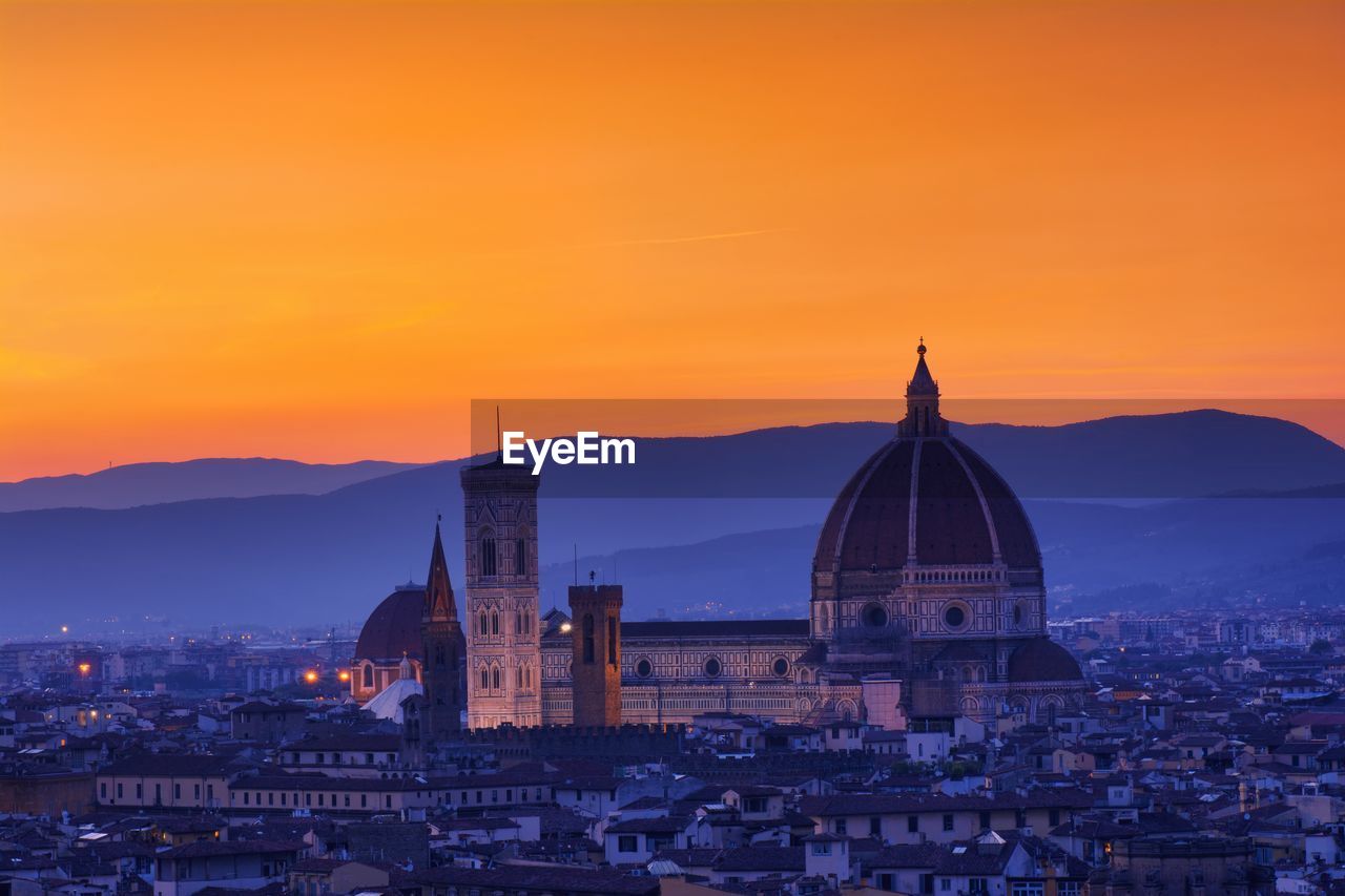 HIGH ANGLE VIEW OF BUILDINGS AT SUNSET