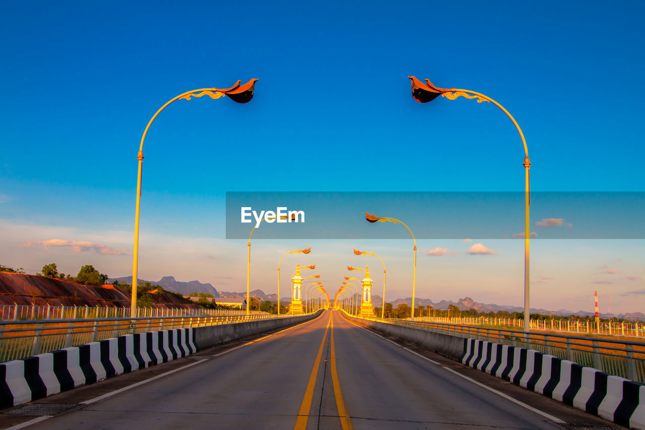 Road against blue sky during sunset