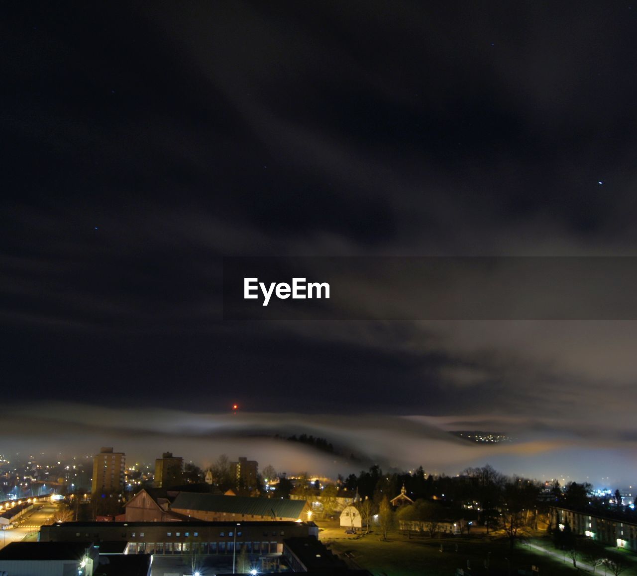 VIEW OF ILLUMINATED CITYSCAPE AT NIGHT